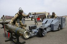 U.S. Air Force Staff Sgt. John Bybee, 177th Aircraft Maintenance Squadron 1-man, guides U.S. Air Force Staff Sgt. Andrew Finnegan, 177th AMXS 2-man, as they prepare to move a GBU-12 Paveway II during the 51st Maintenance Group’s quarterly weapons load crew competition at Osan Air Base, Republic of Korea, April 14, 2017. The Airmen were deployed from the New Jersey Air National Guard’s 177th Fighter Wing to Osan and competed against their active duty counterparts. (U.S. Air Force photo by Staff Sgt. Victor J. Caputo)
