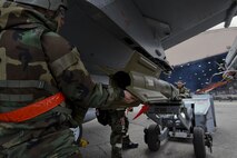 Members of the 36th Aircraft Maintenance Unit compete in a quarterly 51st Maintenance Group weapons load competition at Osan Air Base, Republic of Korea, April 14, 2017. During the competition each team was responsible for loading an AIM-9 Sidewinder, GBU-38 Joint Direct Attack Munition, and GBU-12 Paveway II onto an aircraft frame in a timely manner. (U.S. Air Force photo by Airman 1st Class Gwendalyn Smith)