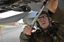 U.S. Air Force Senior Airman Brett Hamblin, 36th Aircraft Maintenance Unit 2-man, prepares an F-16 Fighting Falcon for a missile load during a quarterly 51st Maintenance Group weapons load competition at Osan Air Base, Republic of Korea, April 14, 2017. The top two weapons load crews compete every quarter, and this quarter they were joined by the 177th Aircraft Maintenance Squadron from the New Jersey Air National Guard. (U.S. Air Force photo by Airman 1st Class Gwendalyn Smith)