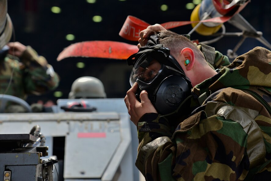 U.S. Air Force Staff Sgt. Kyle Fitzpatrick, 36th Aircraft Maintenance Unit 1-man, dons his gas mask during a quarterly 51st Maintenance Group weapons load competition at Osan Air Base, Republic of Korea, April 14, 2017. Mission Oriented Protective Posture was used to simulate real-life precautions that may be needed in this scenario. (U.S. Air Force photo by Airman 1st Class Gwendalyn Smith)