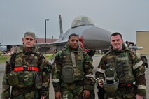 U.S. Air Force Senior Airman Brett Hamblin, left, 36th Aircraft Maintenance Unit 2-man, U.S. Air Force Senior Airman Aaron McBride, 36th AMU 3-man, middle, and U.S. Air Force Staff Sgt. Kyle Fitzpatrick, 36th AMU 1-man, right, stand in front of a F-16 Fighting Falcon after a quarterly 51st Maintenance Group weapons load competition at Osan Air Base, Republic of Korea, April 14, 2017. The top two weapons load crews compete every quarter, and they were joined by the 177th Aircraft Maintenance Squadron from the New Jersey Air National Guard for this quarter’s competition. (U.S. Air Force photo by Airman 1st Class Gwendalyn Smith)