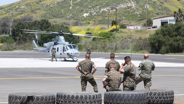 Marines with the School of Infantry West observe a UH-1Y Huey with Marine Light Attack Helicopter Training Squadron 303 during an aerial demonstration at Marine Corps Base Camp Pendleton, Calif., April 11. Marines with HMLAT-303 conducted basic flight maneuvers during the demonstration to build cohesion between air and ground Marines. 