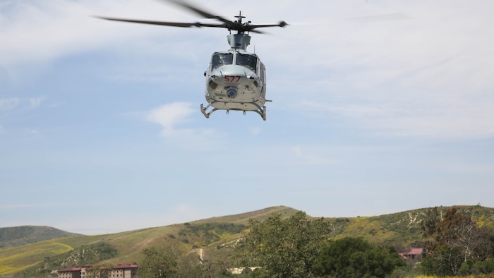 A UH-1Y Huey with Marine Light Attack Helicopter Training Squadron 303 flies over Marines with School of Infantry West during an aerial demonstration at Marine Corps Base Camp Pendleton, Calif., April 11. Marines with HMLAT-303 conducted basic flight maneuvers during the demonstration to build cohesion between air and ground Marines. 