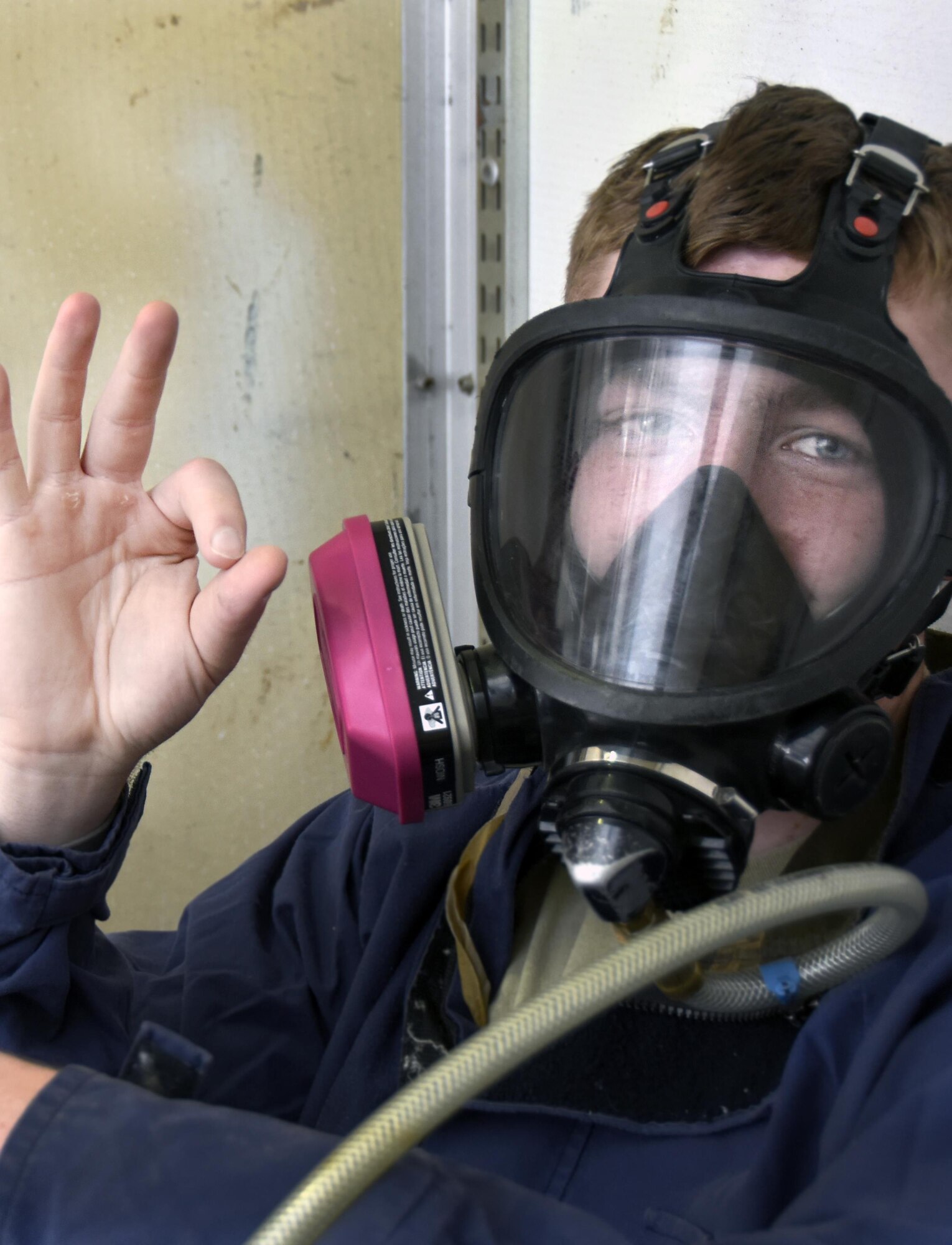 U.S. Air Force Airman 1st Class Austin Milliren, an aircraft fuel systems repair technician with the 379th Expeditionary Maintenance Squadron, signals that he is ready to start his role playing as a trapped technician during a confined space training exercise, April 14, 2017. Given the possible dangers associated with working in a fuel cell, these Airmen counteract the risk by training in realistic scenarios.  (U.S. Air Force photo by Senior Airman Cynthia A. Innocenti)