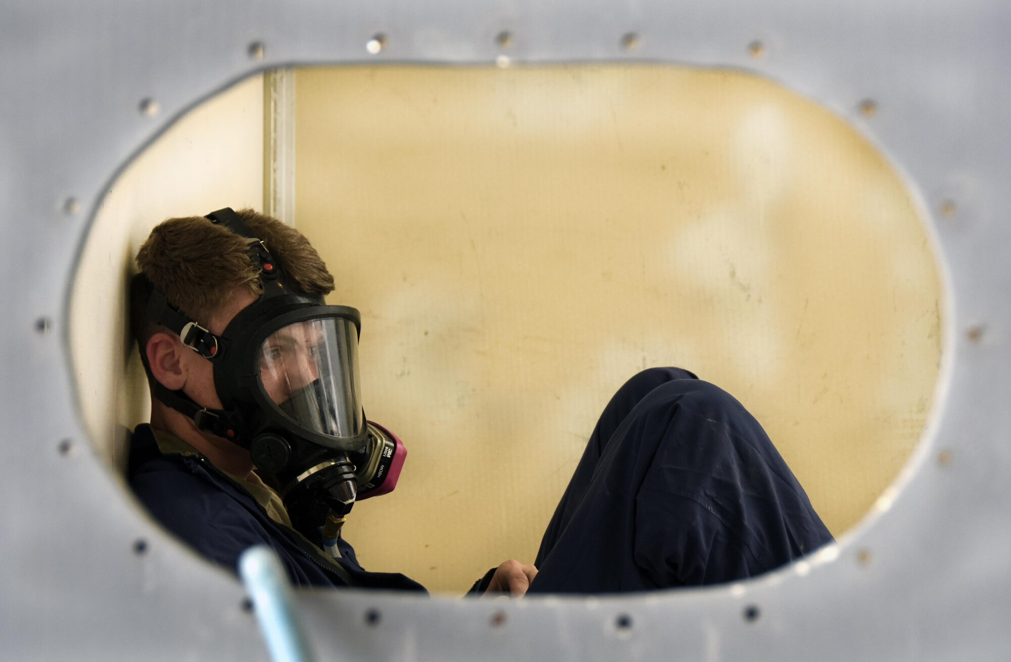 U.S. Air Force Senior Airman Justin Abel, an aircraft fuel systems repair technician with the 379th Expeditionary Maintenance Squadron, role-plays being trapped in a mock fuel cell during a confined space training exercise at Al Udeid Air Base, Qatar, April 14, 2017. This type of training is paramount for these Airmen because of the risks associated with the conditions they may have to work in. (U.S. Air Force photo by Senior Airman Cynthia A. Innocenti)