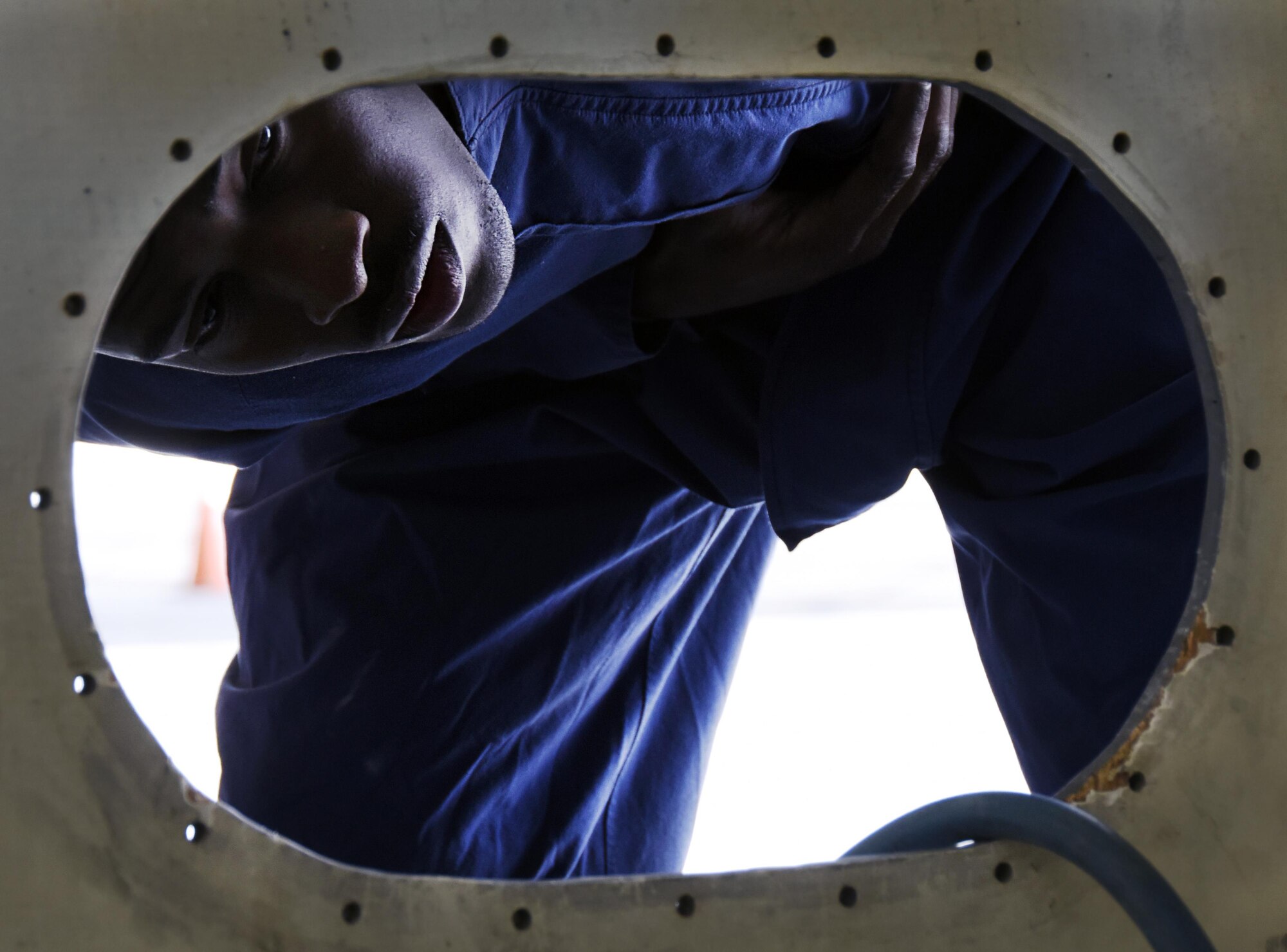 U.S. Air Force Senior Airman Jacob Williams, an aircraft fuel systems repair technician with the 379th Expeditionary Maintenance Squadron, looks into a mock fuel cell during a confined space training exercise at Al Udeid Air Base, Qatar, April 14, 2017. Given the possible dangers associated with working in a fuel cell, these Airmen counteract the risk by training in realistic scenarios. (U.S. Air Force photo by Senior Airman Cynthia A. Innocenti)