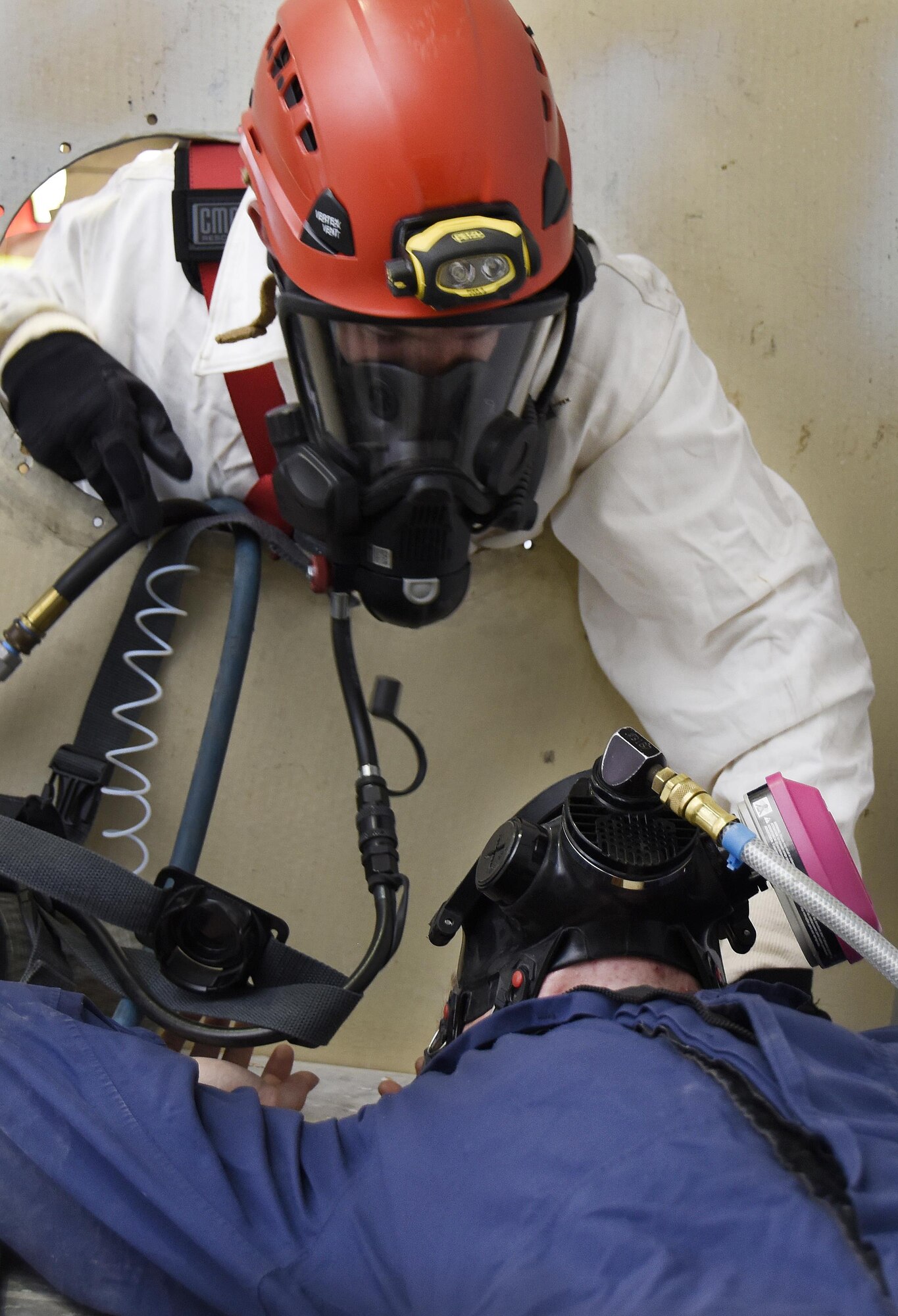 A U.S. Air Force rescue crew Airman with the 379th Expeditionary Civil Engineer Squadron Fire Department extracts a role player simulating a simulating a technician being trapped in a fuel cell during a confined space training exercise at Al Udeid Air Base, Qatar, April 14, 2017. Rescue crew Airmen maintain their readiness with training exercises to mitigate possible mishaps.  (U.S. Air Force photo by Senior Airman Cynthia A. Innocenti)