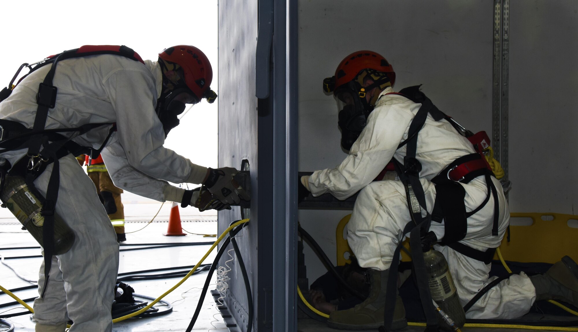 U.S. Air Force rescue crew Airmen with the 379th Expeditionary Civil Engineer Squadron Fire Department extract a role player simulating a technician being trapped in a fuel cell during a confined space training exercise at Al Udeid Air Base, Qatar, April 14, 2017. Rescue crew Airmen maintain their readiness with training exercises to mitigate possible mishaps. (U.S. Air Force photo by Senior Airman Cynthia A. Innocenti)