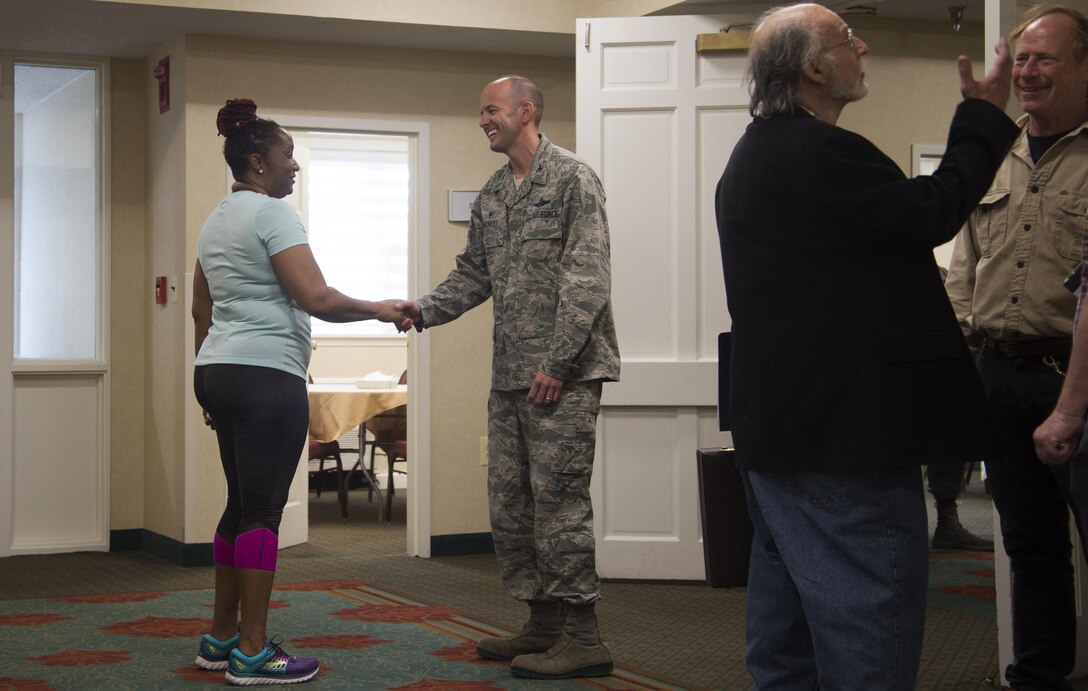 Col. E. John Teichert, 11th Wing and Joint Base Andrews commander, shakes hands with a local community member during a town hall meeting at the Colony South Hotel in Clinton, Md., April 12, 2017. Joint Base Andrews leadership attended the meeting to inform local community members and answer questions about a recent F-16C Fighting Falcon crash. (U.S. Air Force photo by Senior Airman Mariah Haddenham)