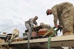 Army Spc. Dartanian Pina and Staff Sgt. Nicholas San Miguel from the 115th BSB, 1st Cavalry Division,unload a pallet of unserviceable parts for recycling to contribute to the 200,000 pounds collected by Fort Hood Recycle.