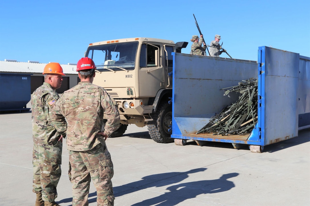 Soldiers from the 62nd ESB, 11th TTSB, recycle unserviceable military equipment as they dispose of a 20-foot container and a Tricon worth of materials during the surge event. 
