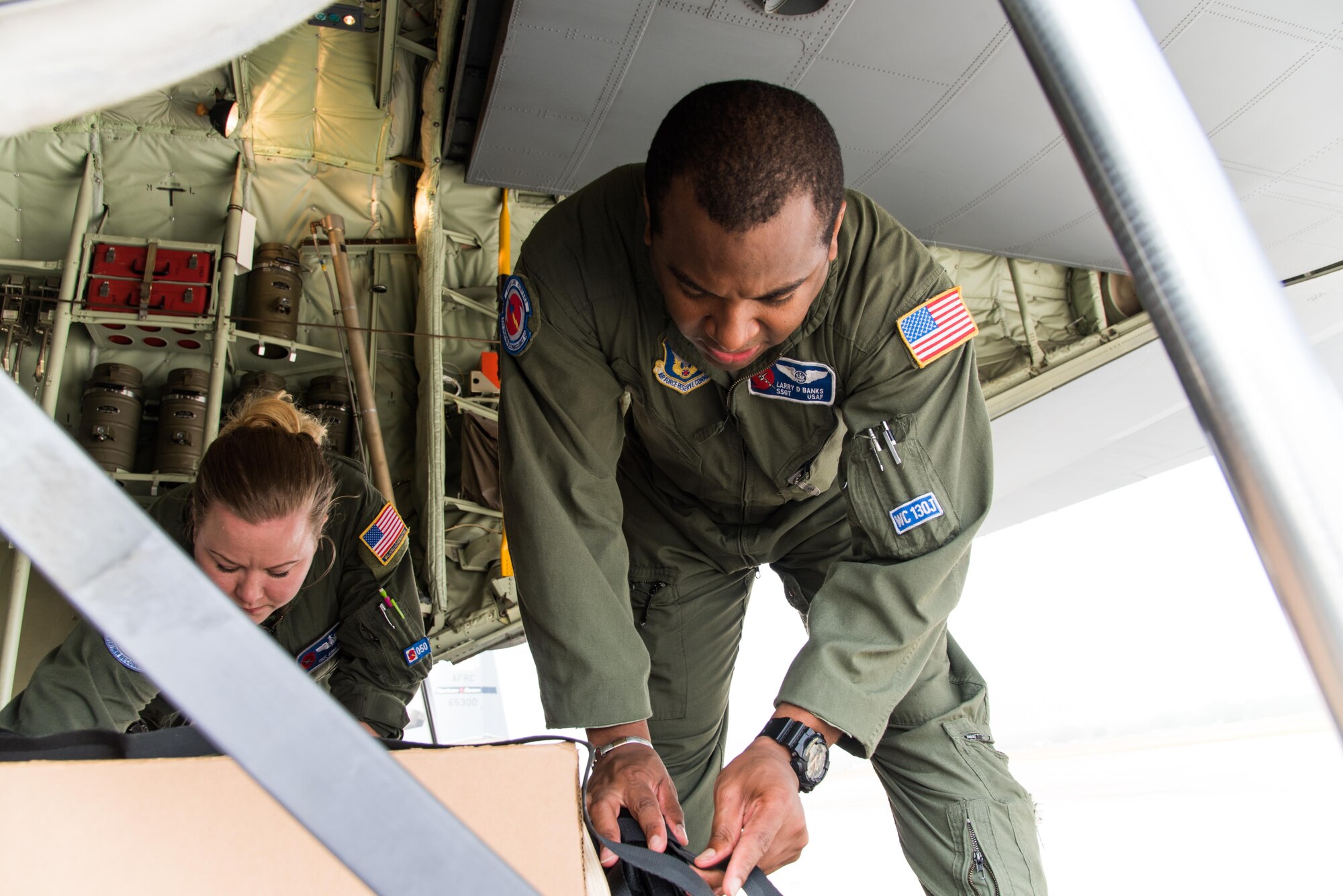 Staff Sgt. Larry Banks and Tech. Sgt. Jenna Daniel, 53rd Weather Reconnaissance Squadron loadmasters, tie down U.S. Navy weather buoys Apirl 12 at Keesler Air Force Base, Mississippi. These buoys were dropped in preparation for the Naval Oceanography unmanned systems Gulf of Mexico Operational Demonstration scheduled to take place May 30 through June 1 in Gulfport. This joint training opportunity allows the 53rd WRS and Navy personnel to practice collecting and analyzing atmospheric and oceanic data.(U.S. Air Force photo/Staff Sgt. Heather Heiney)