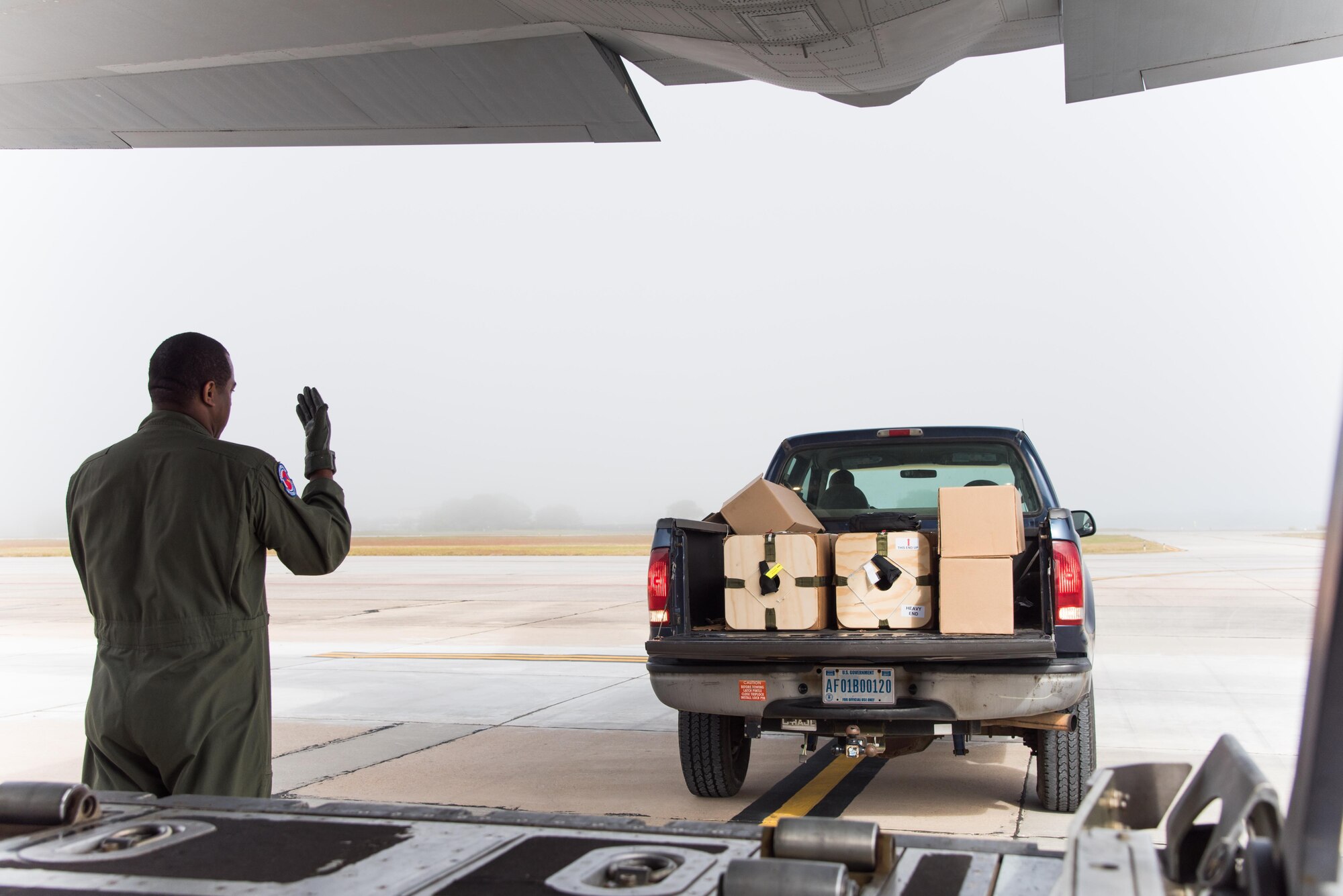 Staff Sgt. Larry Banks, 53rd Weather Reconnaissance Squadron loadmaster, guids a truck with U.S. Navy weather buoys toward a WC-130 Super Hercules Aircraft April 12 at Keesler Air Force Base, Mississippi. These buoys were dropped in preparation for the Naval Oceanography unmanned systems Gulf of Mexico Operational Demonstration scheduled to take place May 30 through June 1 in Gulfport. This joint training opportunity allows the 53rd WRS and Navy personnel to practice collecting and analyzing atmospheric and oceanic data.(U.S. Air Force photo/Staff Sgt. Heather Heiney)