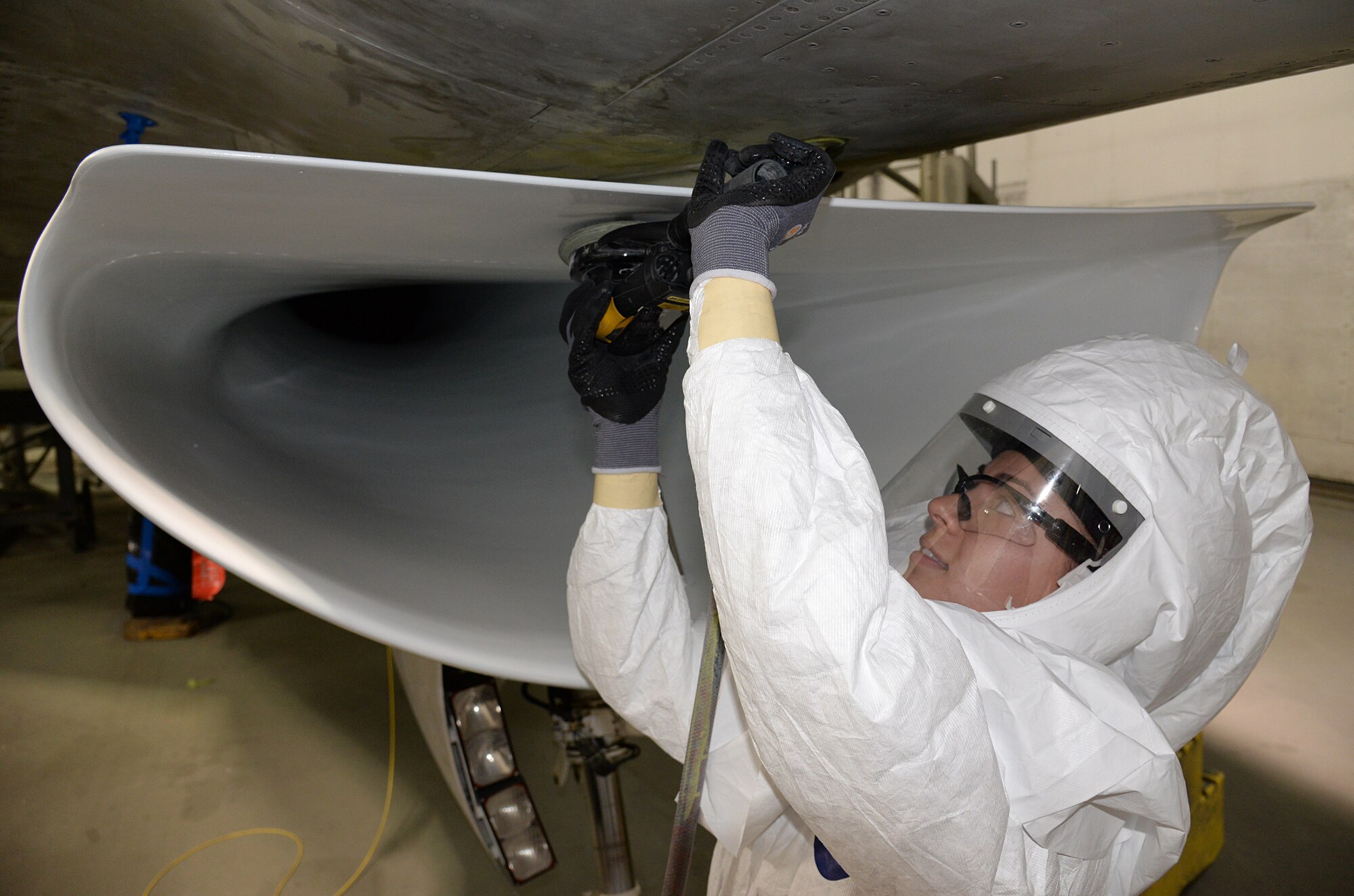 Ms. Chauntel Dwyer, 576 AMXS Corrosion Control specialist, prepares an F-16 intake for repair. Corrosion control is critical to ensure the coating material stays properly bonded to prevent engine damage and reduce the aircrafts radar signature. (U.S. Air Force Photo by Alex R. Lloyd)