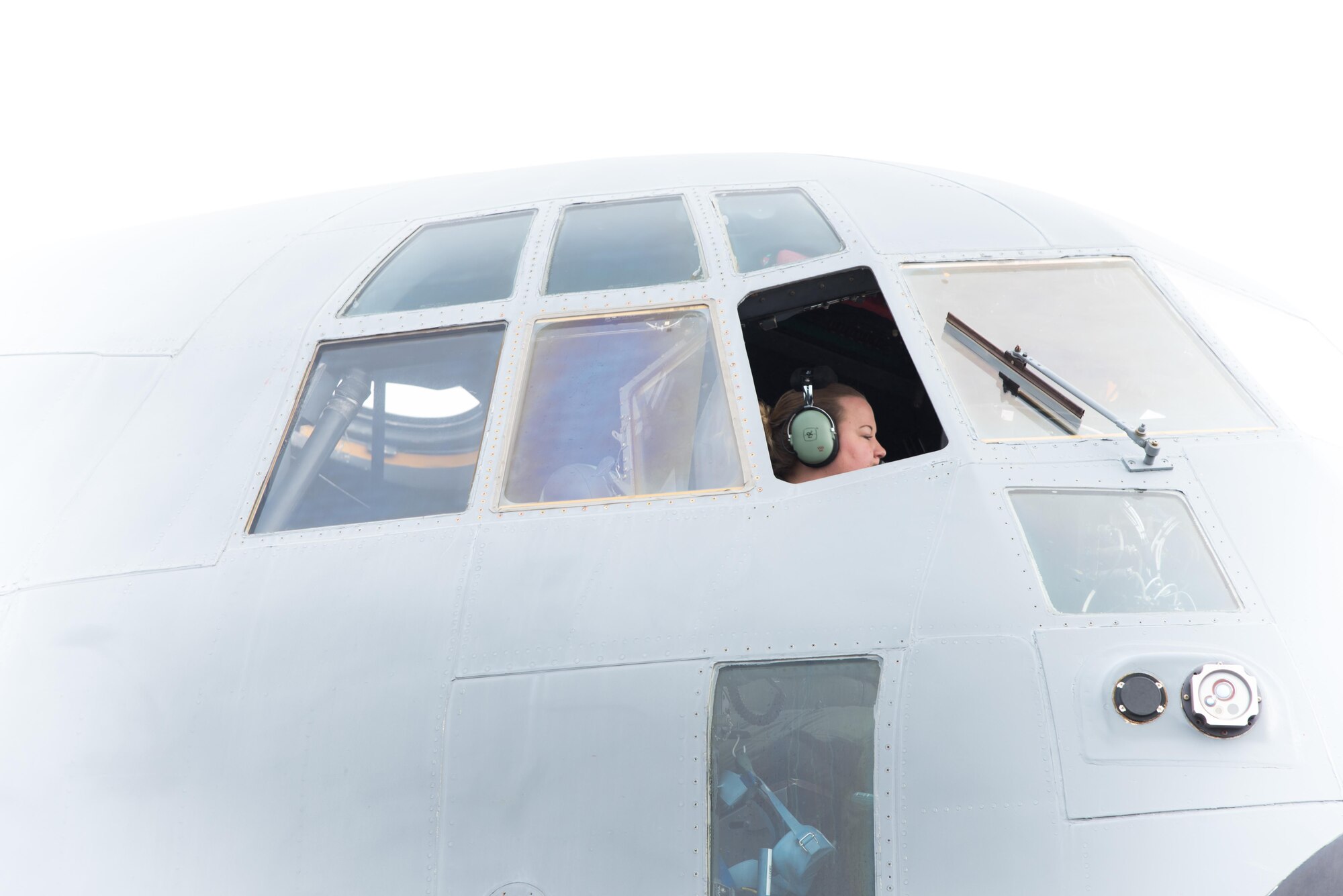 Tech. Sgt. Jenna Daniel, 53rd Weather Reconnaissance Squadron loadmaster, checks equipment on a WC-130J Super Hercules Aircraft on a foggy morning April 12 at Keesler Air Force Base, Mississippi. (U.S. Air Force photo/Staff Sgt. Heather Heiney)