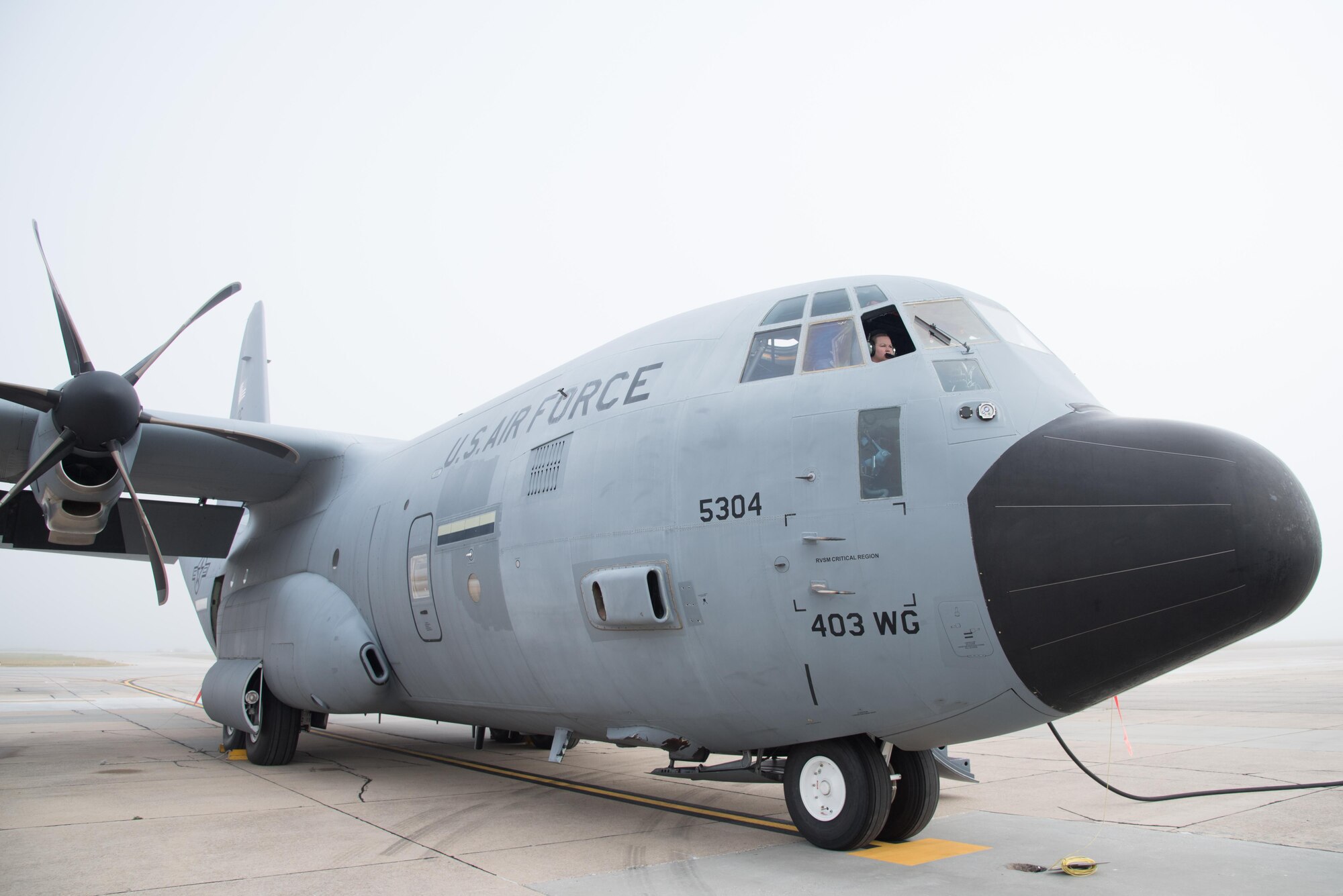Tech. Sgt. Jenna Daniel, 53rd Weather Reconnaissance Squadron loadmaster, checks equipment on a WC-130J Super Hercules Aircraft on a foggy morning April 12 at Keesler Air Force Base, Mississippi. (U.S. Air Force photo/Staff Sgt. Heather Heiney)
