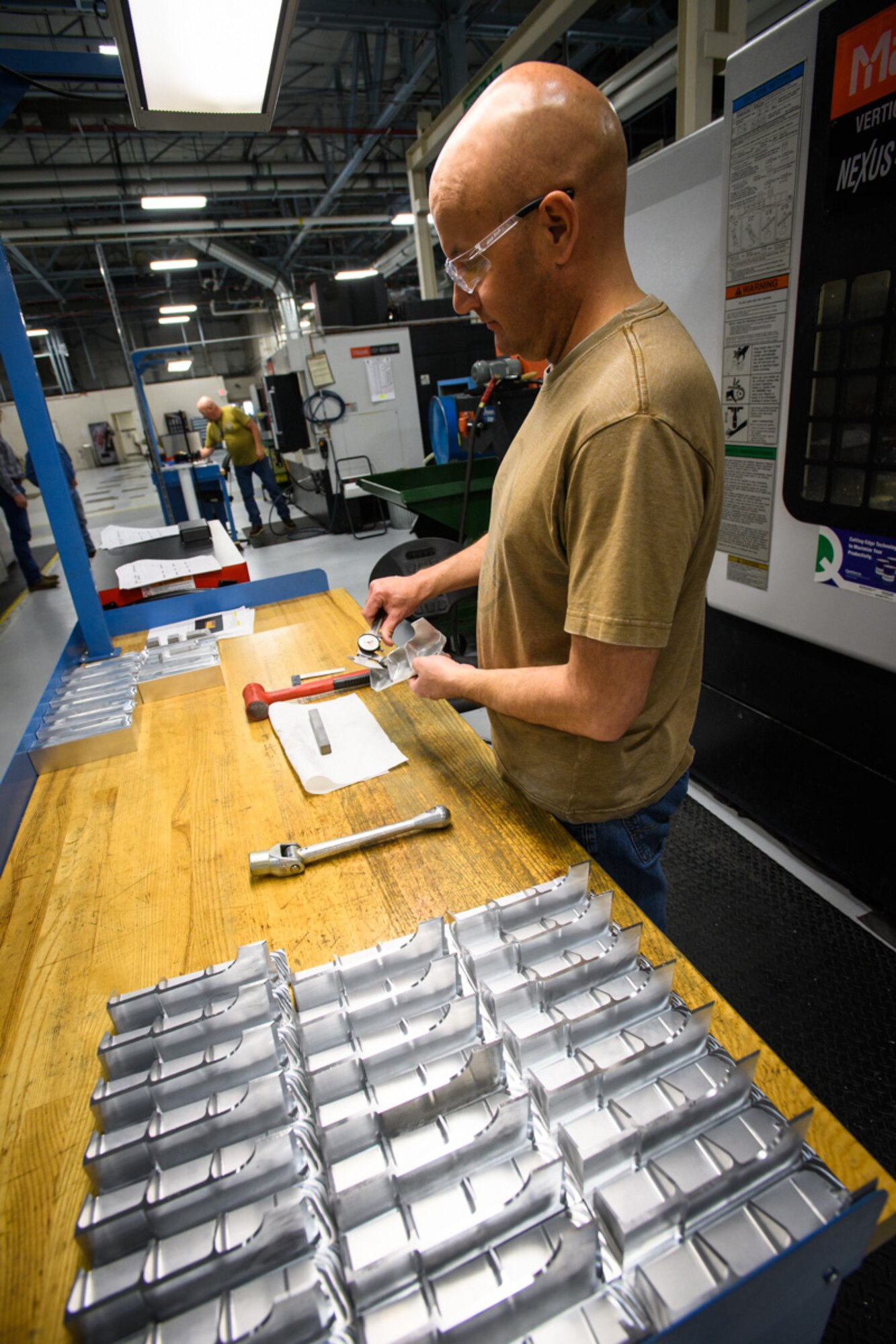 Machinist Tom Henrie, 532nd Commodities Maintenance Squadron, checks dimensions on an A-10 Thunderbolt II aircraft fitting, Hill Air Force Base, Utah, March 20, 2017. Team Hill’s local manufacturing shop produces parts for every airframe in the United States Air Force fleet. (U.S. Air Force photo/R. Nial Bradshaw)