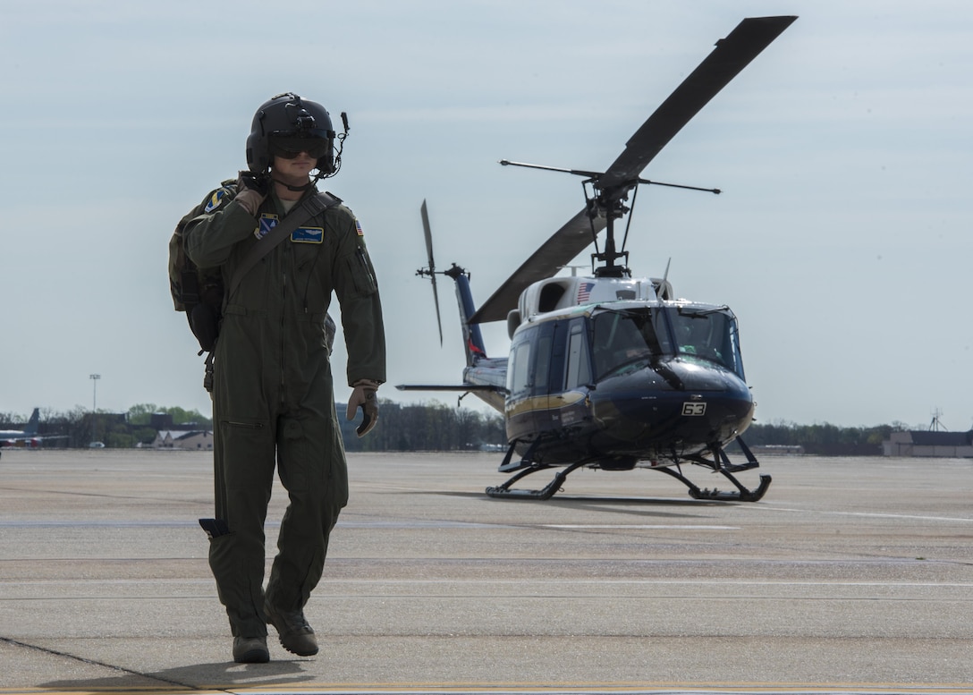 Capt. Jason Pettengill, 11th Wing executive officer, walks past a 1st Helicopter Squadron UH-1N Iroquois after a flight at Joint Base Andrews, Md., April 13, 2017. The 1st HS played a role in the F-16 Fighting Falcon crash six miles southwest of JBA by recovering a downed pilot, who sustained non-life threatening injuries. (U.S. Air Force photo by Senior Airman Jordyn Fetter)