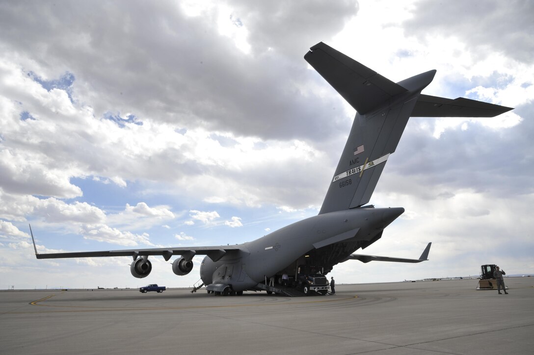 A C-17 Globemaster III from the 60th Air Mobility Wing at Travis Air Force Base, California sits on the flight line at Kirtland Air Force Base, New Mexico March 21. The Globemaster was on station as part of a five-base joint effort to transport a Universal Ground Nuclear Detonation Detection Terminal (UGNT) trailer. (U.S. Air Force photo by Senior Airman Nigel Sandridge)