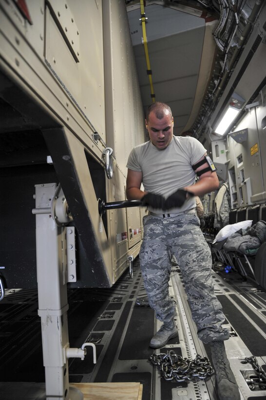 Senior Airman Robert Jared, 377th Logistics Readiness Squadron air terminal specialist, stabilizes the Universal Ground Nuclear Detonation Detection Terminal trailer on a C-17 Globemaster III at Kirtland Air Force Base, March 21. Loading is a slow and careful process to assure that the aircraft and the asset remain as unharmed as possible. (U.S. Air Force photo by Senior Airman Nigel Sandridge)