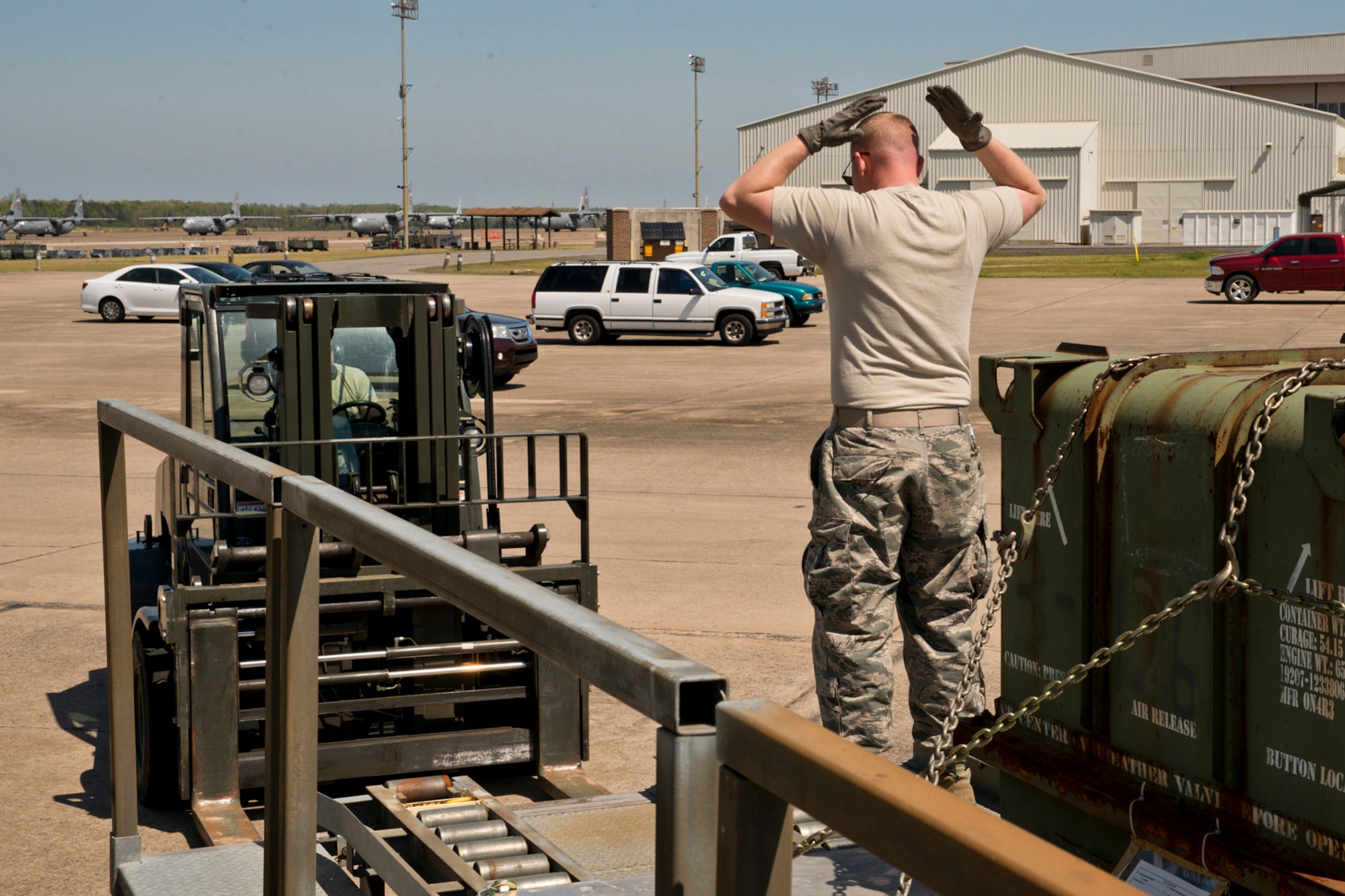 U.S. Air Force Reserve Tech Sgt. Jason Gibson, air transportation journeyman, 96th Aerial Port Squadron, directs a forklift driver during a practice session April 1, 2017, at Little Rock Air Force Base, Ark. Gibson is part of a team that will be competing in this year’s Port Dawg Challenge at Dobbins Air Reserve Base, Ga. (U.S. Air Force photo by Master Sgt. Jeff Walston/Released)