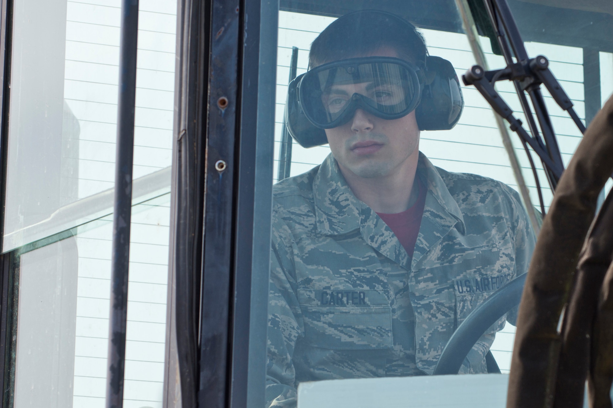 U.S. Air Force Reserve Senior Airman Jacob Carter, air transportation journeyman, 96th Aerial Port Squadron, awaits orders to load a C-130J Super Hercules during a training exercise April 2, 2017, at Little Rock Air Force Base, Ark. Carter is one member of a team preparing to compete in the 2017 Port Dawg Challenge for air mobility professionals, at Dobbins Air Reserve Base, Ga. (U.S. Air Force photo by Master Sgt. Jeff Walston/Released)