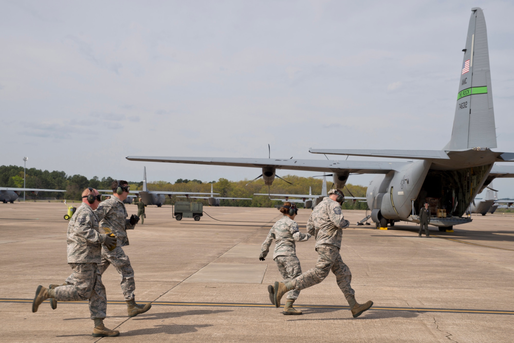 (Left to Right) U.S. Air Force Reserve Tech Sgt. Jason Gibson, Tech Sgt. Danny Canup, Tech Sgt. Kristen Garrett and Master Sgt. Morgan Abner race to a C-130J Super Hercules, where they will unload what they just loaded, in preparation for the 2017 Port Dawg Challenge for air mobility professionals. The competition, which the 96 APS won in 2012, will be held at Dobbins Air Reserve Base, Ga. (U.S. Air Force photo by Master Sgt. Jeff Walston/Released)