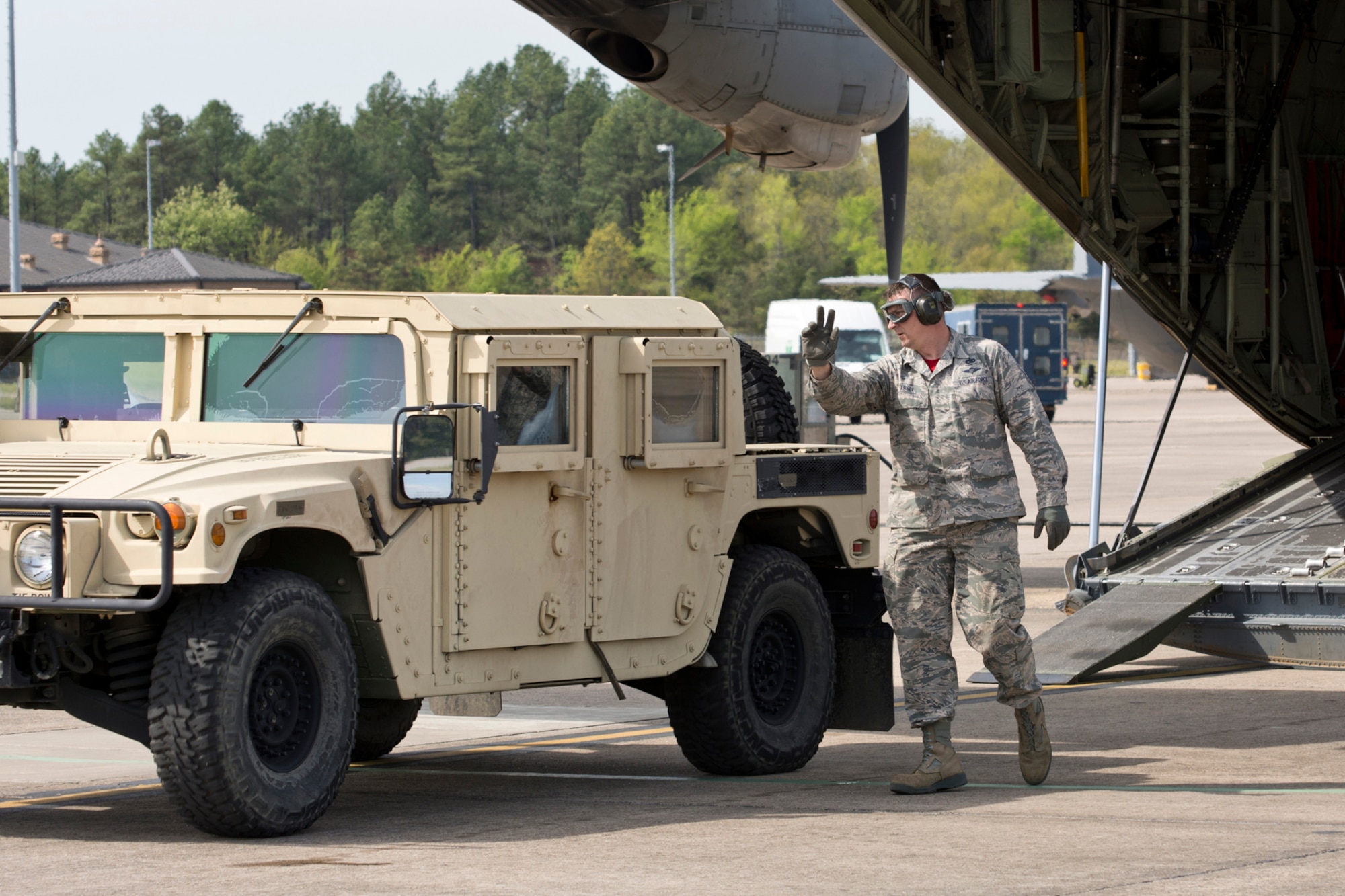 U.S. Air Force Reserve Master Sgt. Morgan Abner, air transportation craftsman, 96th Aerial Port Squadron, directs the driver of a Humvee during a training exercise April 2, 2017, at Little Rock Air Force Base, Ark. Abner is one member of a team preparing to compete in the 2017 Port Dawg Challenge for air mobility professionals, which the 96 APS won in 2012, at Dobbins Air Reserve Base, Ga.,. (U.S. Air Force photo by Master Sgt. Jeff Walston/Released)