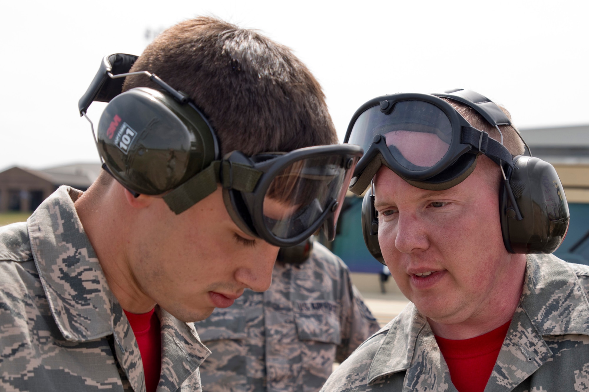 U.S. Air Force Reserve Senior Airman Jacob Carter, air transportation journeyman, 96th Aerial Port Squadron, gets a piece of advice from Tech Sgt. Jason Gibson, air transportation journeyman, 96 APS, during a training exercise April 2, 2017, at Little Rock Air Force Base, Ark. The two Airmen are part of a team preparing for a competition between air mobility professionals. (U.S. Air Force photo by Master Sgt. Jeff Walston/Released)
