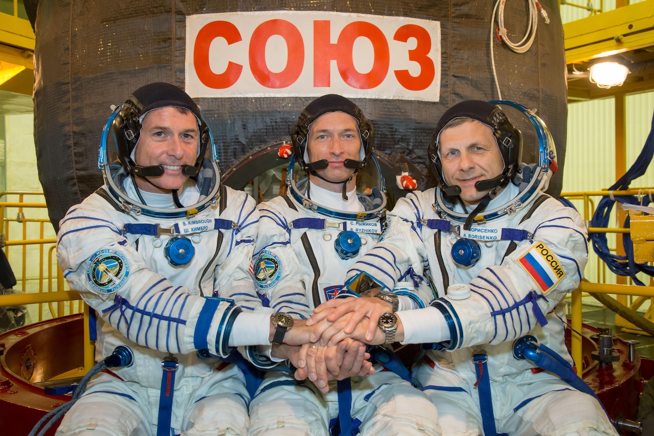 At the Integration Facility at the Baikonur Cosmodrome in Kazakhstan, Expedition 49 crewmembers Shane Kimbrough of NASA (left) and Sergey Ryzhikov (center) and Andrey Borisenko (right) of Roscosmos pose for pictures Sept. 9 in front of their Soyuz MS-02 spacecraft during a pre-launch training fit check. Kimbrough, Ryzhikov and Borisenko will launch Sept. 24, Kazakh time on the Soyuz MS-02 vehicle for a five-month mission on the International Space Station.

NASA/Victor Zelentsov