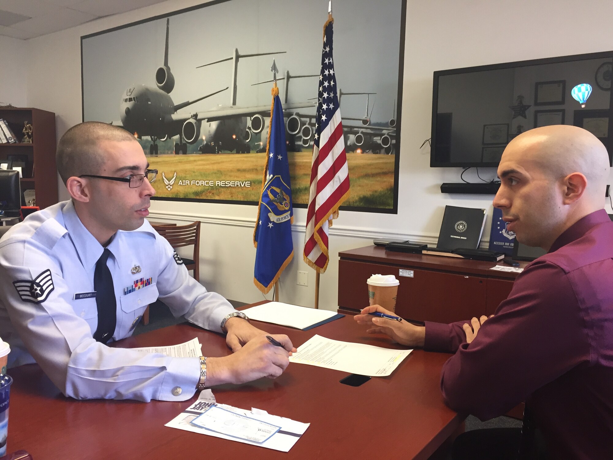 Staff Sgt. Anthony McCourt, 514th Air Mobility Wing recruiter, talks with Ruben Rios, a New York City Firefighter who recently took the oath of enlistment to join the Air Force Reserves. After completing his basic training, Rios plans on becoming a public affairs specialist at the 514th AMW. 