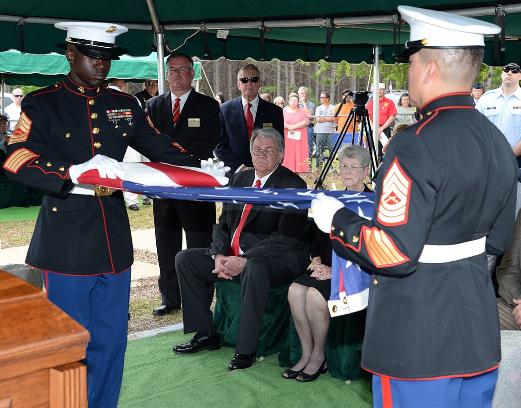 Master Sgt. Jeremy Singleton, left, and Master Sgt. Robert Nolasco, both with Marine Corps Logistics Base Albany funeral detail, fold an American flag during the burial of Marine Pfc. James O. Whitehurst at Cowarts Baptist Church Cemetery in Cowarts, Ala., April 12. Whitehurst was killed in action while fighting the Japanese at the battle of Tarawa during World War II, Nov. 20, 1943.