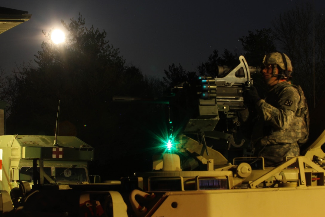 U.S. Army Reserve Spc. Jake Bloss, 366th Engineer Company, 412th Theater Engineer Command, watches another crew complete basic night live-fire during Operation Cold Steel at Fort McCoy, Wis., April 11, 2017. Operation Cold Steel is the U.S. Army Reserve's crew-served weapons qualification and validation exercise to ensure that America's Army Reserve units and Soldiers are trained and ready to deploy on short-notice and bring combat-ready and lethal firepower in support of the Army and our joint partners anywhere in the world. (U.S. Army Reserve photo by Staff Sgt. Debralee Best, 84th Training Command)