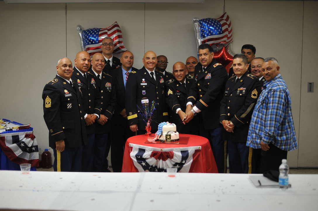 The Retirees participate in the cake cutting ceremony moments after a retirement ceremony held at Ramon Hall on Fort Buchanan, April 8.