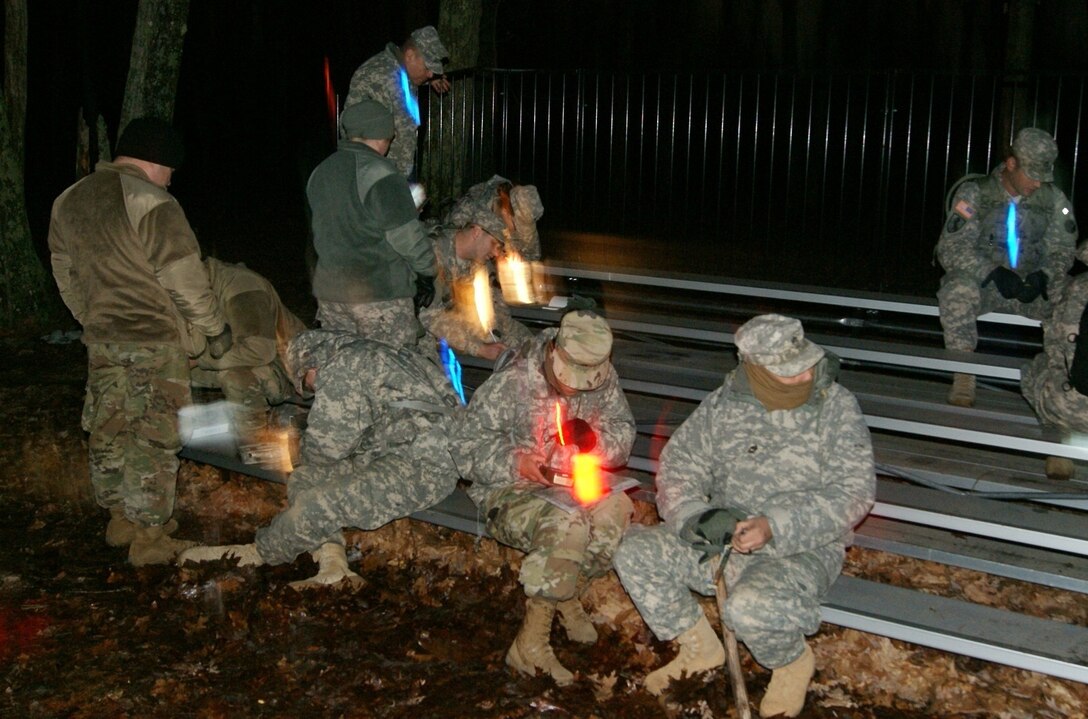 Competitors use chem-lights for their land navigation event at Fort Devens, Massachusetts, April 5, 2017, as part of the 2017 Joint 80th Training Command and 99th Regional Support Command Best Warrior Competition.