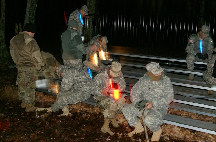 Competitors use chem-lights for their land navigation event at Fort Devens, Massachusetts, April 5, 2017, as part of the 2017 Joint 80th Training Command and 99th Regional Support Command Best Warrior Competition.