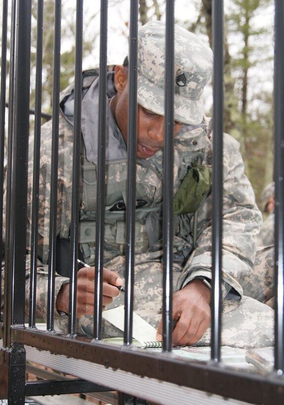 Competitor Staff Sgt. Thomas Lewis, of the 94th Training Division, determines his course of action for the land navigation event at Fort Devens, Massachusetts, April 5, 2017, as part of the 2017 Joint 80th Training Command and 99th Regional Support Command Best Warrior Competition.