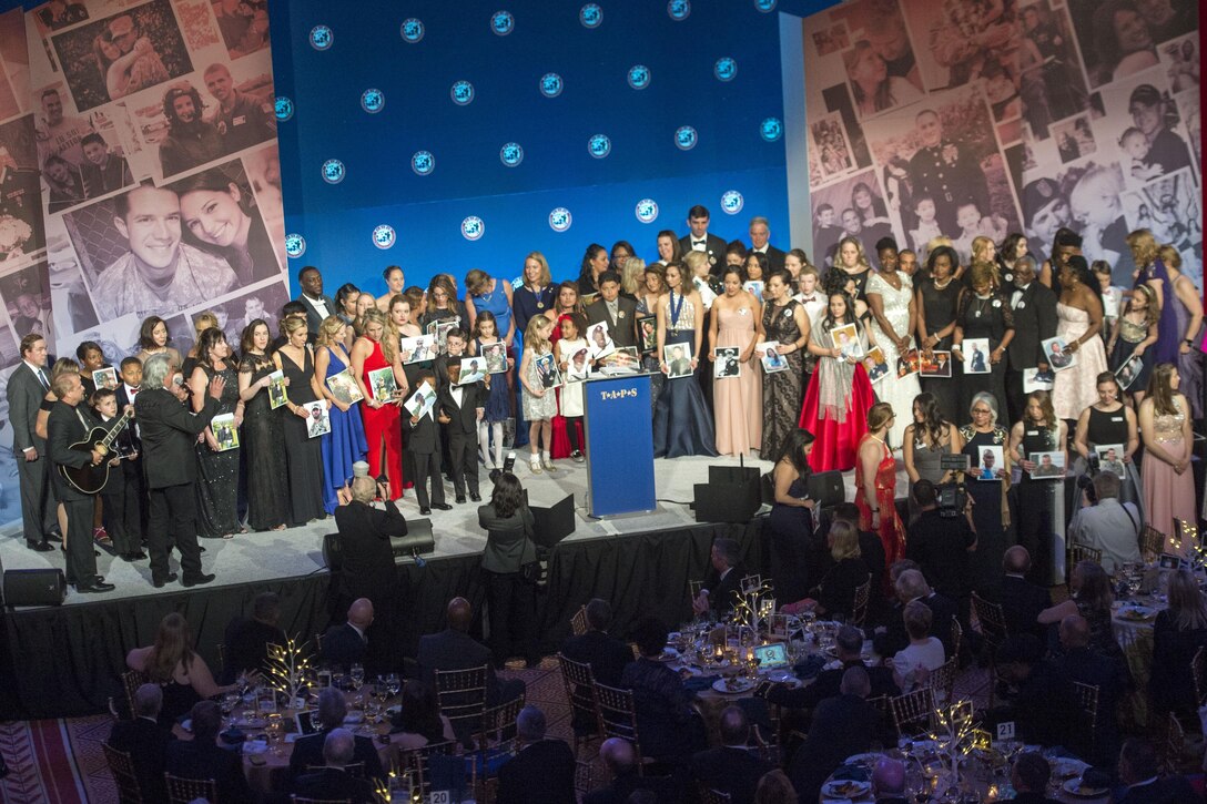 Surviving family members hold portraits of loved ones during the Tragedy Assistance Program for Survivors 2017 Honor Guard Gala in Washington, D.C., April 12, 2017. DoD photo by Navy Petty Officer 2nd Class Dominique Pineiro