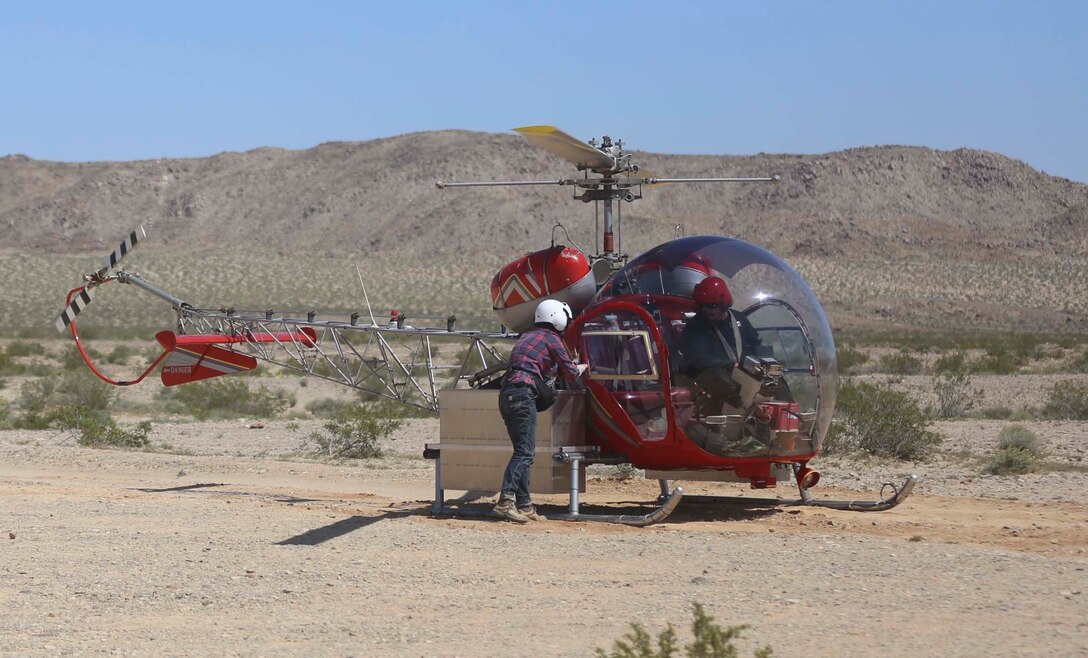 A biologist with Natural Resources and Environmental Affairs places desert tortoises into a carrying case on a helicopter during the Desert Tortoise translocation, April 10, 2017, which was facilitated by the Marine Corps Air Ground Combat Center, Twentynine Palms, Calif. The translocation, in accordance with the U.S. Fish and Wildlife Service-signed Biological Opinion, serves as a negotiated mitigation to support a congressionally mandated land expansion which, will afford the Combat Center the ability to conduct Large Scale Exercise training of a Marine Expeditionary Brigade-level force. (U.S. Marine Corps photo by Cpl. Medina Ayala-Lo)