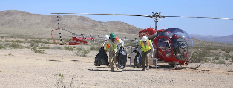 Employees from Natural Resources and Environmental Affairs, remove empty bins for desert tortoises from a helicopter during the Desert Tortoise translocation, April 10, 2017, which was facilitated by the Marine Corps Air Ground Combat Center, Twentynine Palms, Calif. The translocation, in accordance with the U.S. Fish and Wildlife Service-signed Biological Opinion, serves as a negotiated mitigation to support a congressionally mandated land expansion which, will afford the Combat Center the ability to conduct Large Scale Exercise training of a Marine Expeditionary Brigade-level force. (U.S. Marine Corps photo by Cpl. Medina Ayala-Lo)