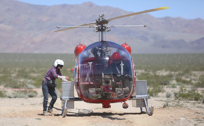 A biologist with Natural Resources and Environmental Affairs places desert tortoises into a carrying case on a helicopter during the Desert Tortoise translocation, April 10, 2017, which was facilitated by the Marine Corps Air Ground Combat Center, Twentynine Palms, Calif. The translocation, in accordance with the U.S. Fish and Wildlife Service-signed Biological Opinion, serves as a negotiated mitigation to support a congressionally mandated land expansion which, will afford the Combat Center the ability to conduct Large Scale Exercise training of a Marine Expeditionary Brigade-level force. (U.S. Marine Corps photo by Cpl. Medina Ayala-Lo)