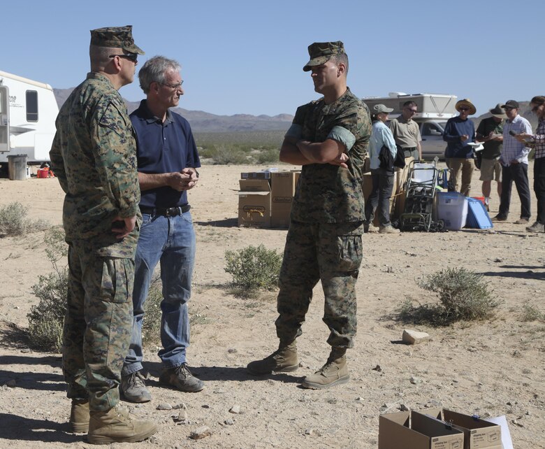 Dr. Brian Henen, base ecologist, Natural Resources and Environmental Affairs, explains the desert tortoise’s behavior to the Commanding General, Brig. Gen. William F. Mullen III, April 12, 2017, during the Desert Tortoise translocation aboard the Marine Corps Air Ground Combat Center, Twentynine Palms, Calif. The translocation, in accordance with the U.S. Fish and Wildlife Service-signed Biological Opinion, serves as a negotiated mitigation to support the mandated land expansion which will afford the Combat Center the ability to conduct Large Scale Exercise training featuring up to a Marine Expeditionary Brigade-level force. (U.S. Marine Corps photo by Lance Cpl. Natalia Cuevas)