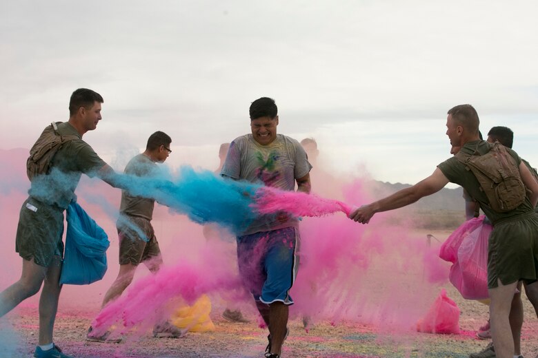 Marines throw colored powder onto participants of the Sexual Assault Prevention and Response annual Colorful Consent 5k Run held aboard Marine Corps Air Ground Combat Center, Twentynine Palms, Calif., April 7, 2017. (U.S. Marine Corps Photo by Cpl. Julio McGraw)