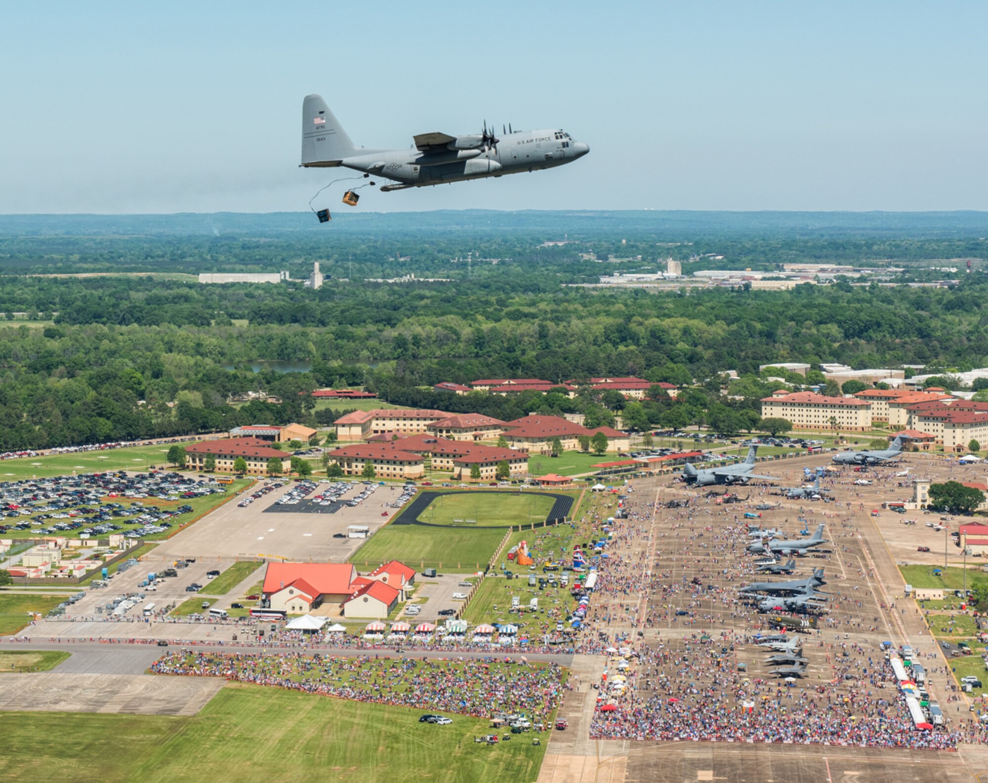 Aircraft number 9143, a C-130 Hercules belonging to the 908th Airlift Wing drops a Containerized Delivery System Bundle on Maxwell Air Force Base April 9 as a part of the Maxwell Air Show. The 908th had four aircraft drop CDS bundles each day of the airshow, along with an aircraft for display and one used by the U.S. Air Force Academy’s parachute team, The Wings of Blue.  (Courtesy photo)