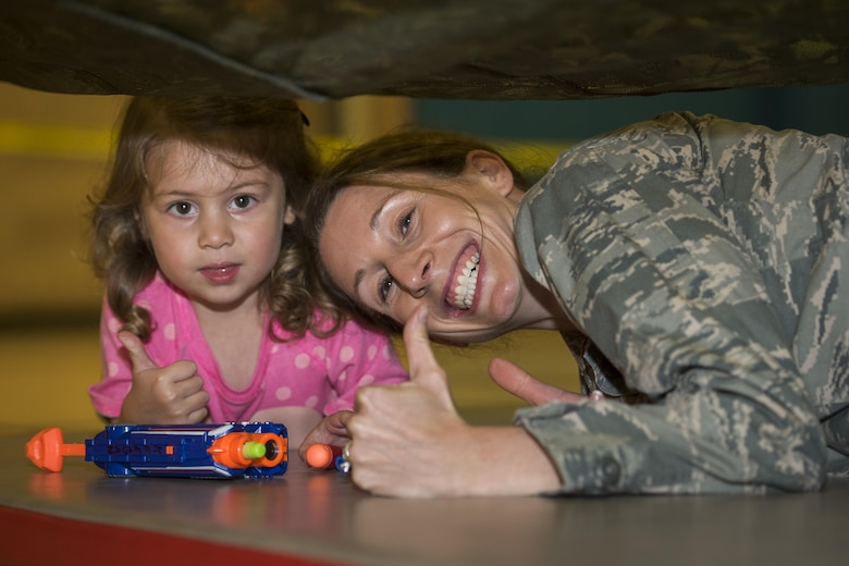 Capt. Kathryn Escatel, Sheppard Family Advocacy program officer, participates in the family Nerf night with her 3-year-old daughter, Vaeda, at the Madrigal Youth Center, April 13, 2017. The Nerf night was held to encourage families to unplug from electronic devices and spend time bonding as families. (U.S. Air Force photo by Staff Sgt. Kyle E. Gese)