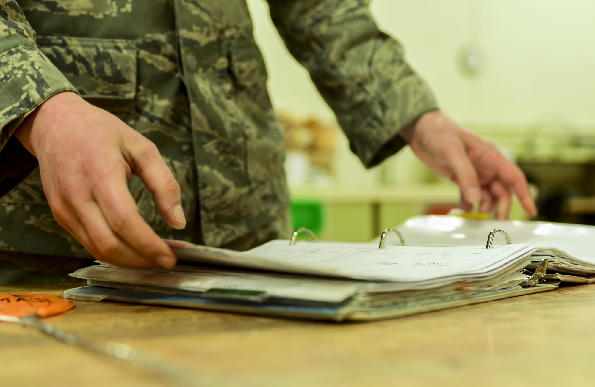 Senior Airman Mark Lee, an Electrical and Environmental craftsman assigned to the 28th Maintenance Squadron, opens a binder inside the E&E back shop at Ellsworth Air Force Base, S.D, April 12, 2017. While troubleshooting components of the B-1 bomber, E&E Airmen sign in parts, assess the problem, order equipment and fix the parts as necessary. (U.S. Air Force photo by Airman 1st Class Randahl J. Jenson)