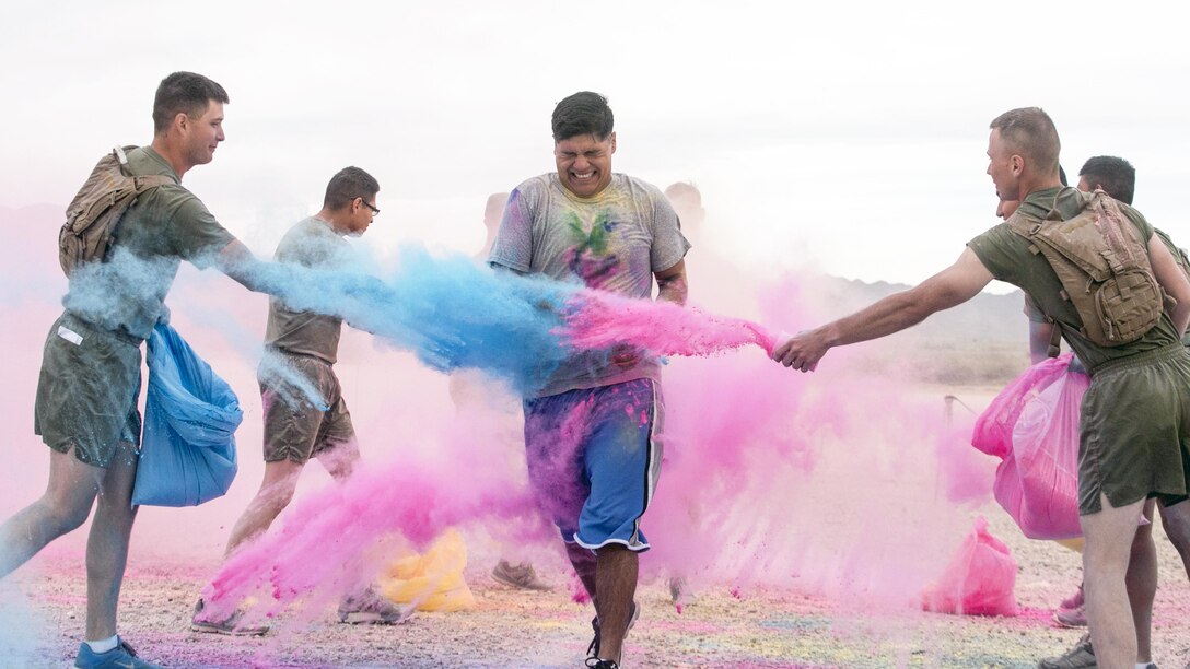 Marines throw colored powder onto participants of the annual Colorful Consent 5k Run to mark Sexual Assault Awareness and Prevention Month at Marine Corps Air Ground Combat Center Twentynine Palms, Calif., April 7, 2017. Marine Corps Photo by Cpl. Julio McGraw
