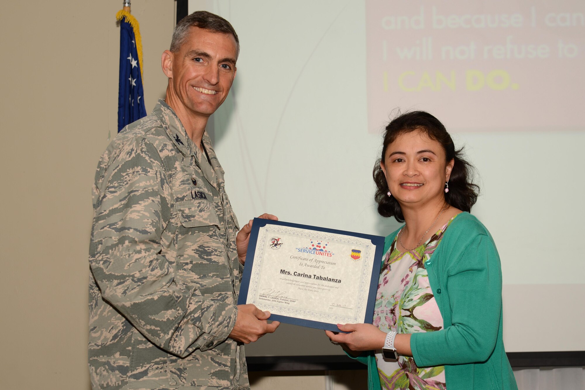 U.S. Air Force Col. Daniel Lasica, 20th Fighter Wing commander, presents Maria Carina Tabalanza, 20th Component Maintenance Squadron executive assistant, with a certificate of appreciation at Shaw Air Force Base, S.C., April 13, 2017. Tabalanza was recognized for her efforts as a volunteer and 20th Fighter Wing Chapel Sunday school teacher. (U.S. Air Force photo by Airman 1st Class Kathryn R.C. Reaves)