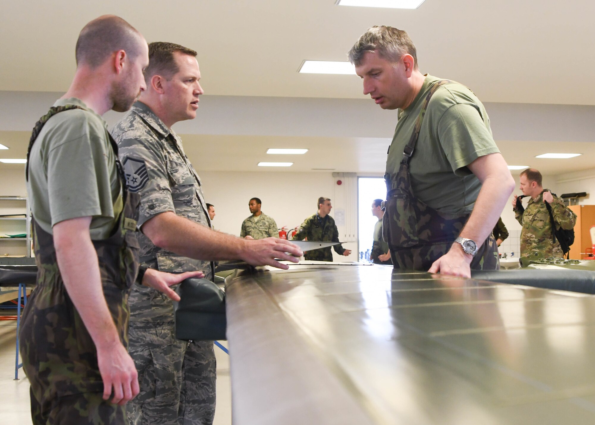 U.S. Air Force Master Sgt. Corey Wacker, maintenance management analyst with the 155th Air Refeuling Wing, Nebraska Air National Guard, discusses maintenance procedures of helicopter rotor blades with members of the 22nd Air Base, March 22, 2017 at 22nd Air Base, Namest nab Oslavou, Czech Republic. Members of the 22nd Air Base gave a tour to Air National Guard members to show their helicopters. (Air National Guard photo by Senior Airman De’Jon Williams)