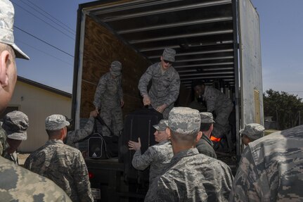 U.S. Air Force Airmen from Osan Air Base, Republic of Korea, receive their belongings following their arrival to Wolf Pack Park, an alternate lodging area at Kunsan Air Base, ROK, April 12, 2017. U.S. Air Force, Army, Marine Corps and Navy personnel and aircraft will train with the Republic of Korea Air Forces in the annual, bilateral training Exercise MAX THUNDER 17, which will be hosted at Kunsan Air Base, Republic of Korea, April 17-28, 2017.